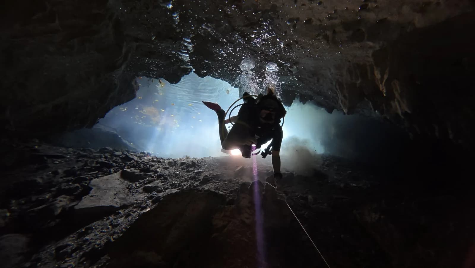 A diver with a torch inside Padre Nuestro