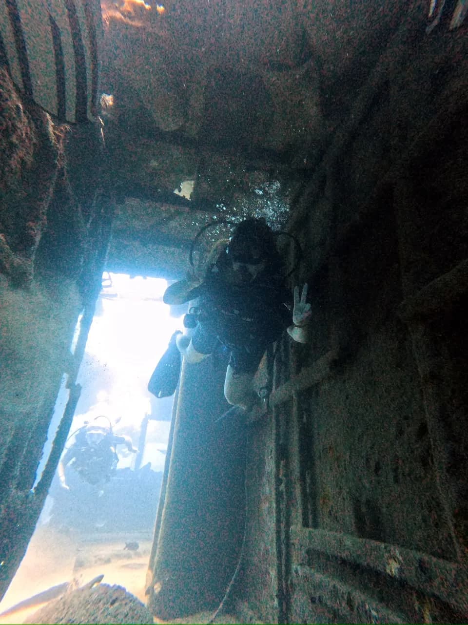 A diver in a passageway inside the wreck