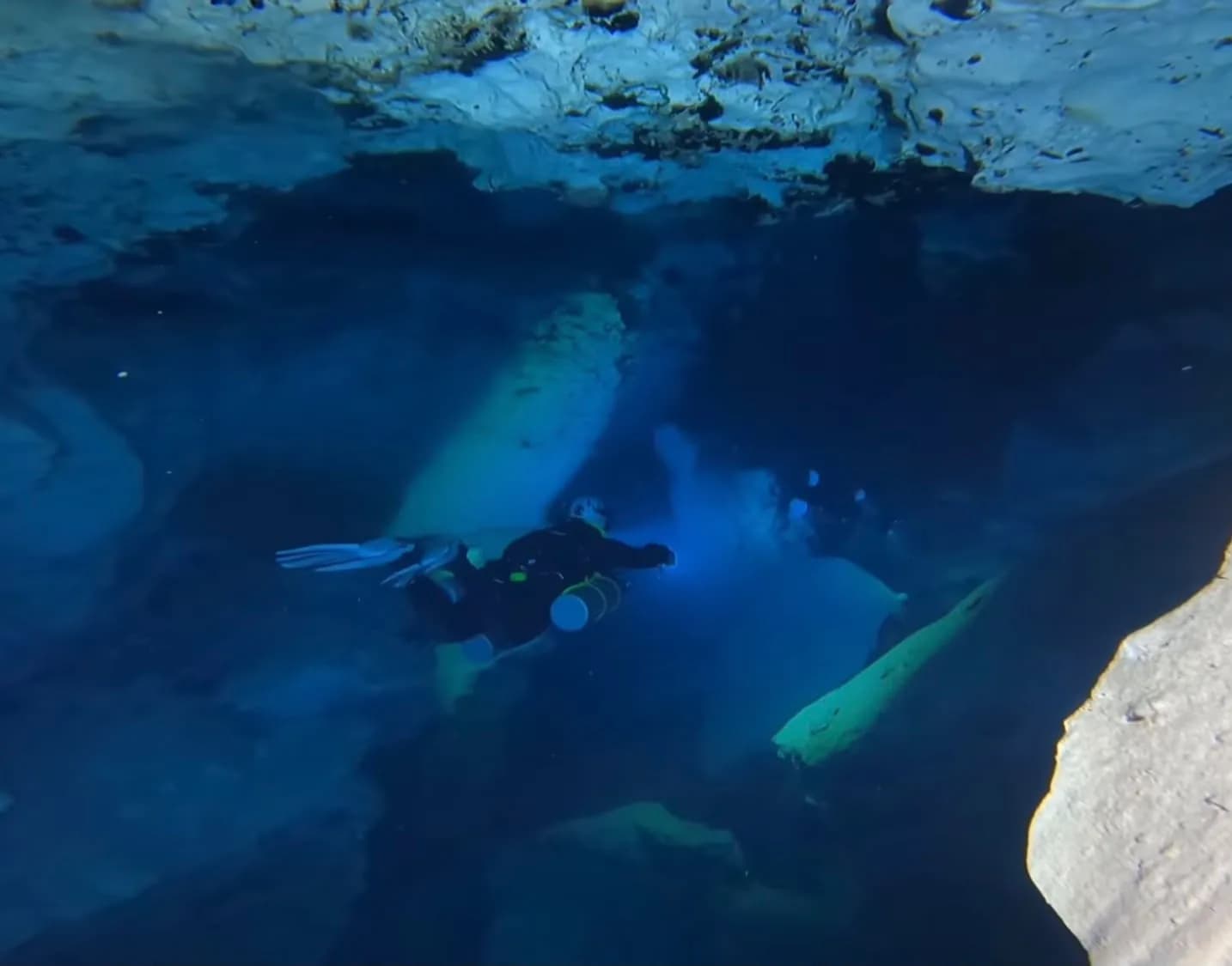 Sidemount diver in the blue water of El Toro